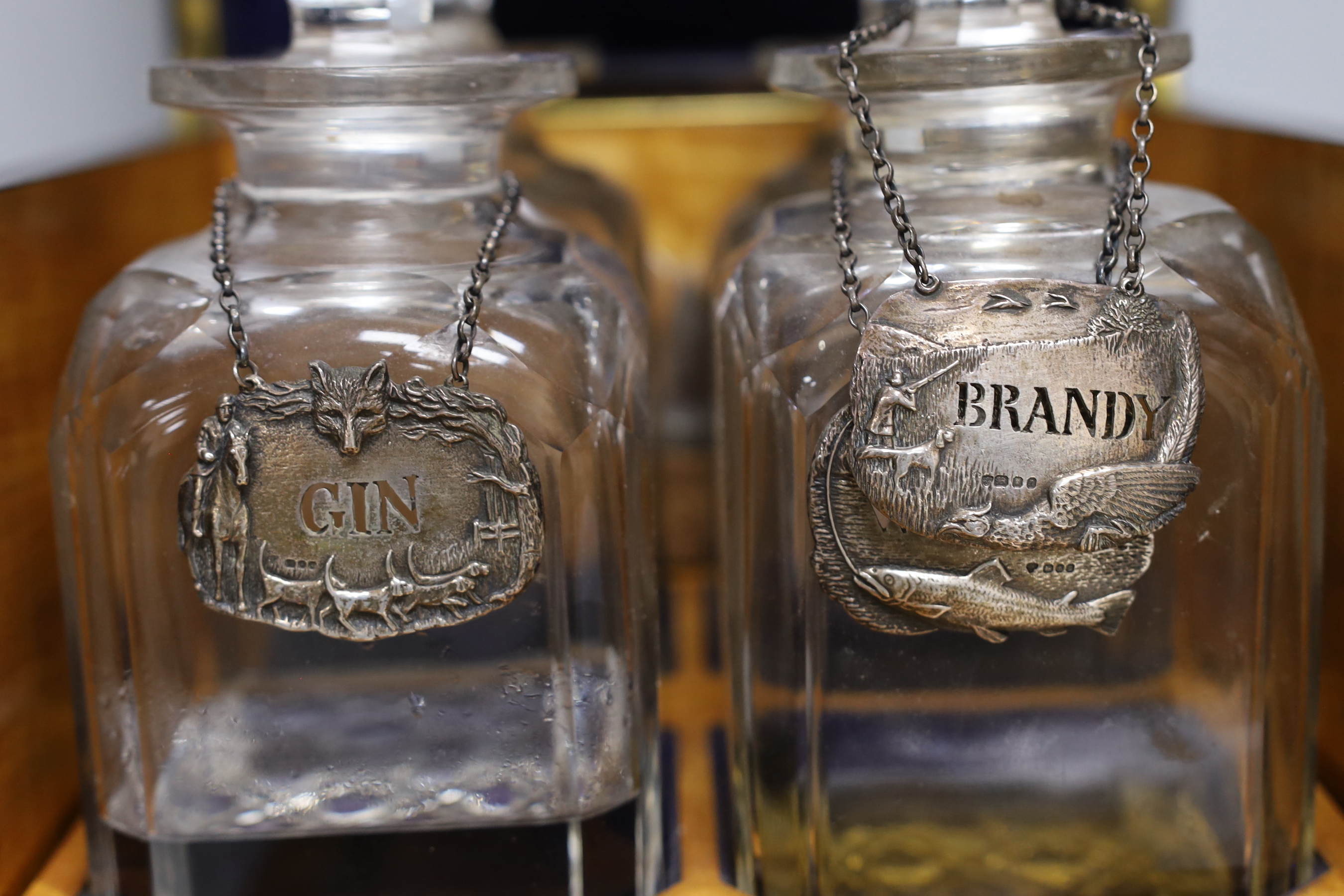 A Victorian coromandel four bottle decanter box with Bramah lock, three silver ‘hunting’ spirit labels and another enamelled, height of box 30cm